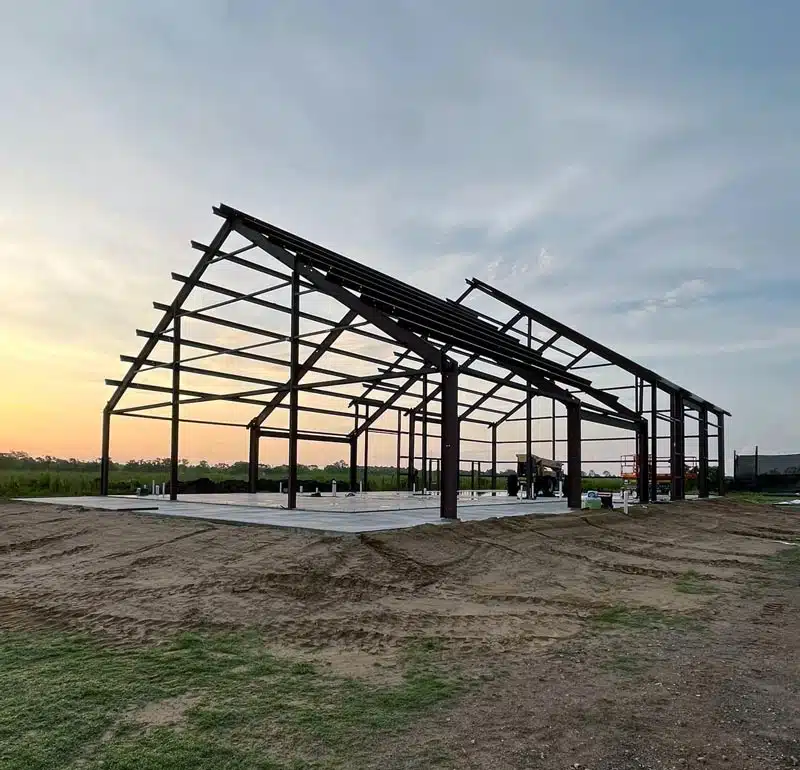 Barndominium frame at sunset in Alabama